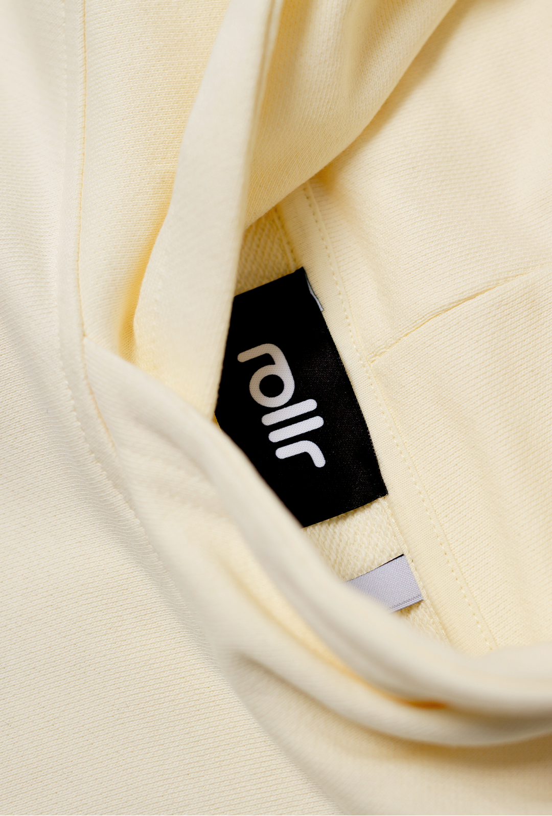 rollr clothing heavyweight vanilla cream box fit hoodie made from french terry fabric and rollr logo print and black label with rollr logo